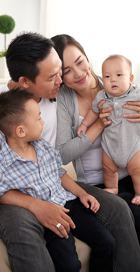 Jerri Green for Governor happy asian husband wife two kids sitting couch home 1